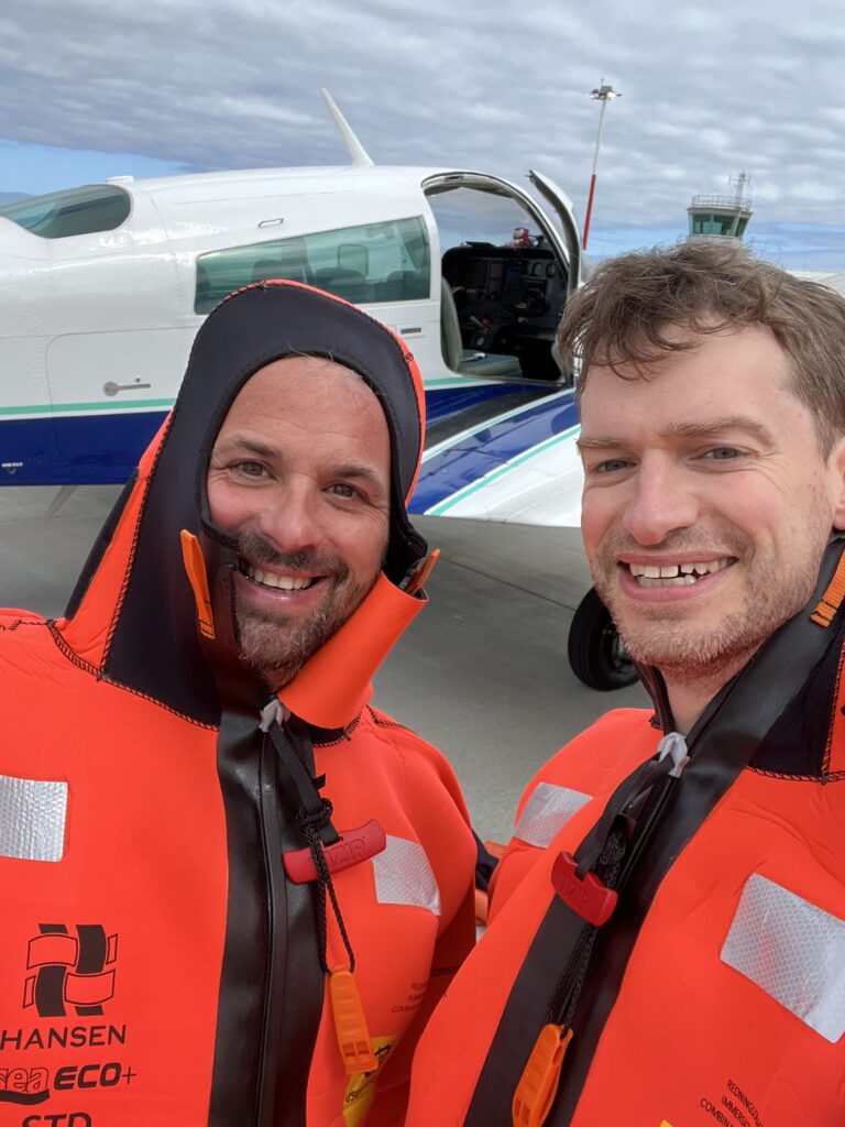 Dave and Daniel wearing orange immersion suits